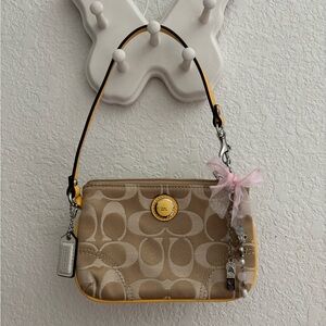 Coach Tan Signature Mini Wristlet with Yellow Trim and Pink Bow Charm